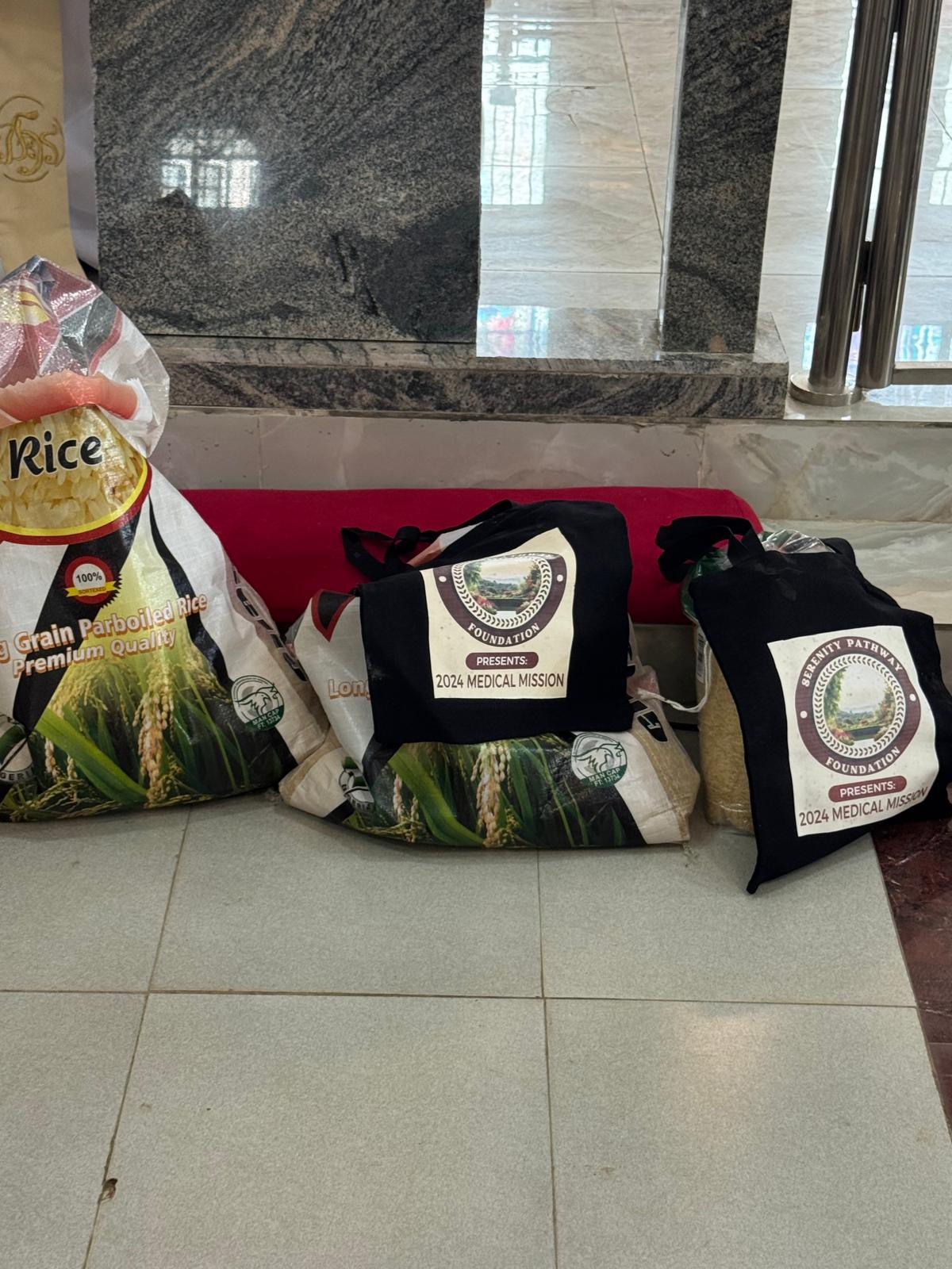 Bags of rice and branded 2024 Medical Mission tote bags prepared for distribution